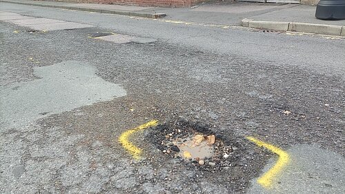 a large pothole in the road