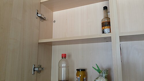 Empty cupboard with just a few half empty jars