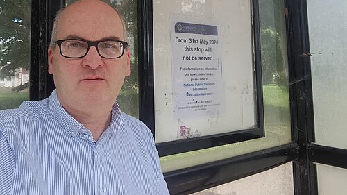 Michael Headley beside a disused bus stop
